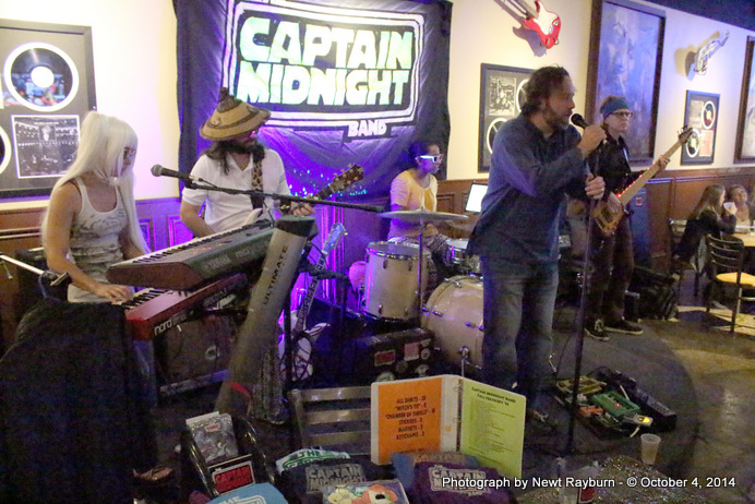 Chris Sartin, owner of Soulshine Pizza Factory, sings "Will The Circle Be Unbroken" with The Captain Midnight Band in honor of Stan Sandroni, Ole Miss' radio personality who recently passed away.